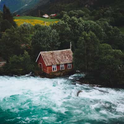 Red cabin near river Oldeelva, Olden, Norway