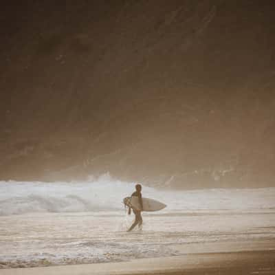 Surfer at Praia da Arrifana, Western Algarve, Portugal