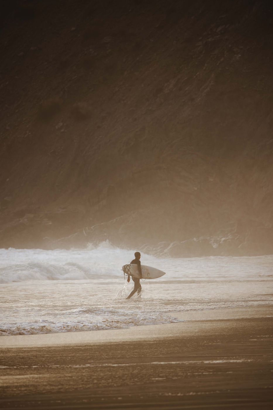 Surfer at Praia da Arrifana, Western Algarve, Portugal