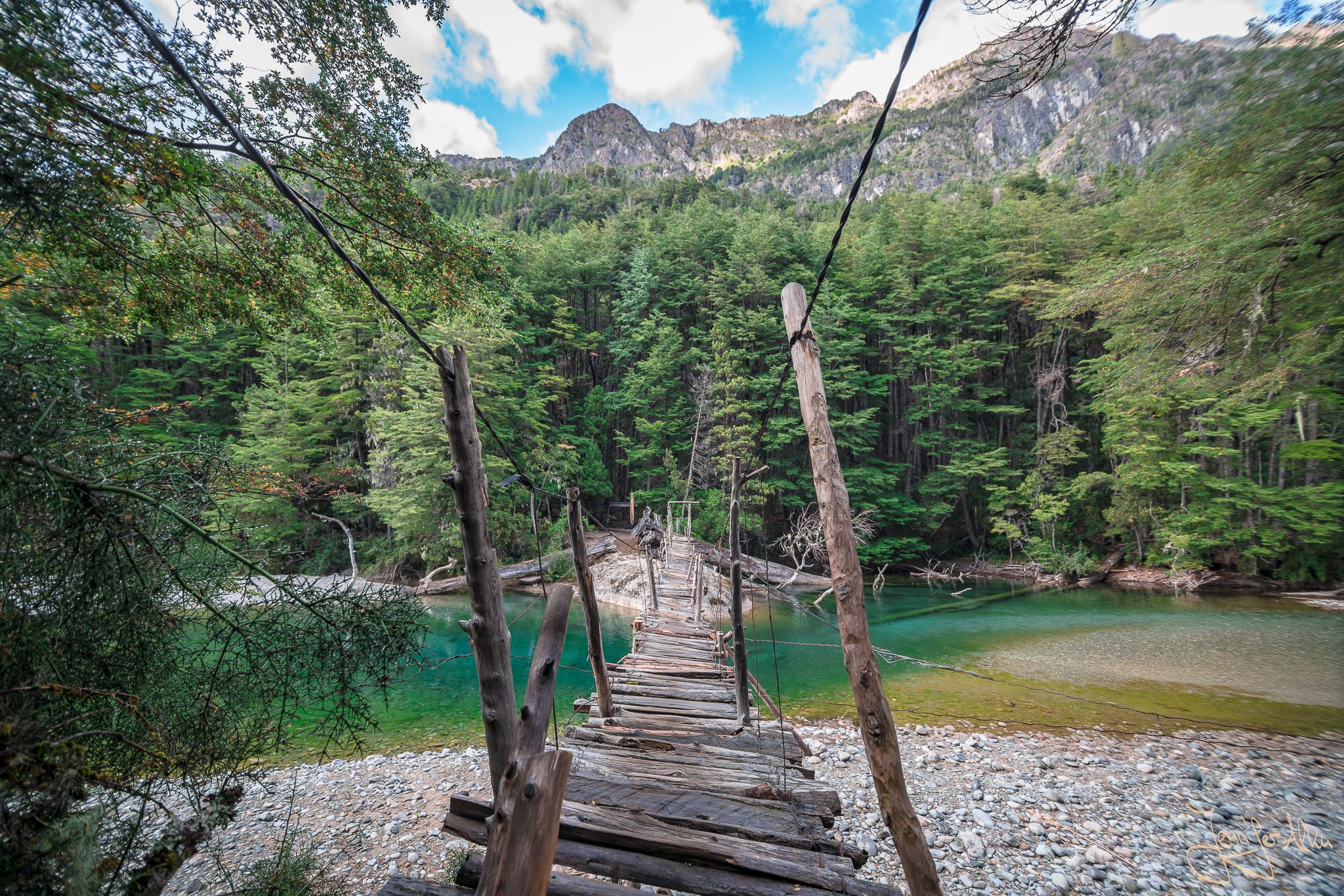 Wooden bridge over river Rio Azul, El Bolson, Argentina