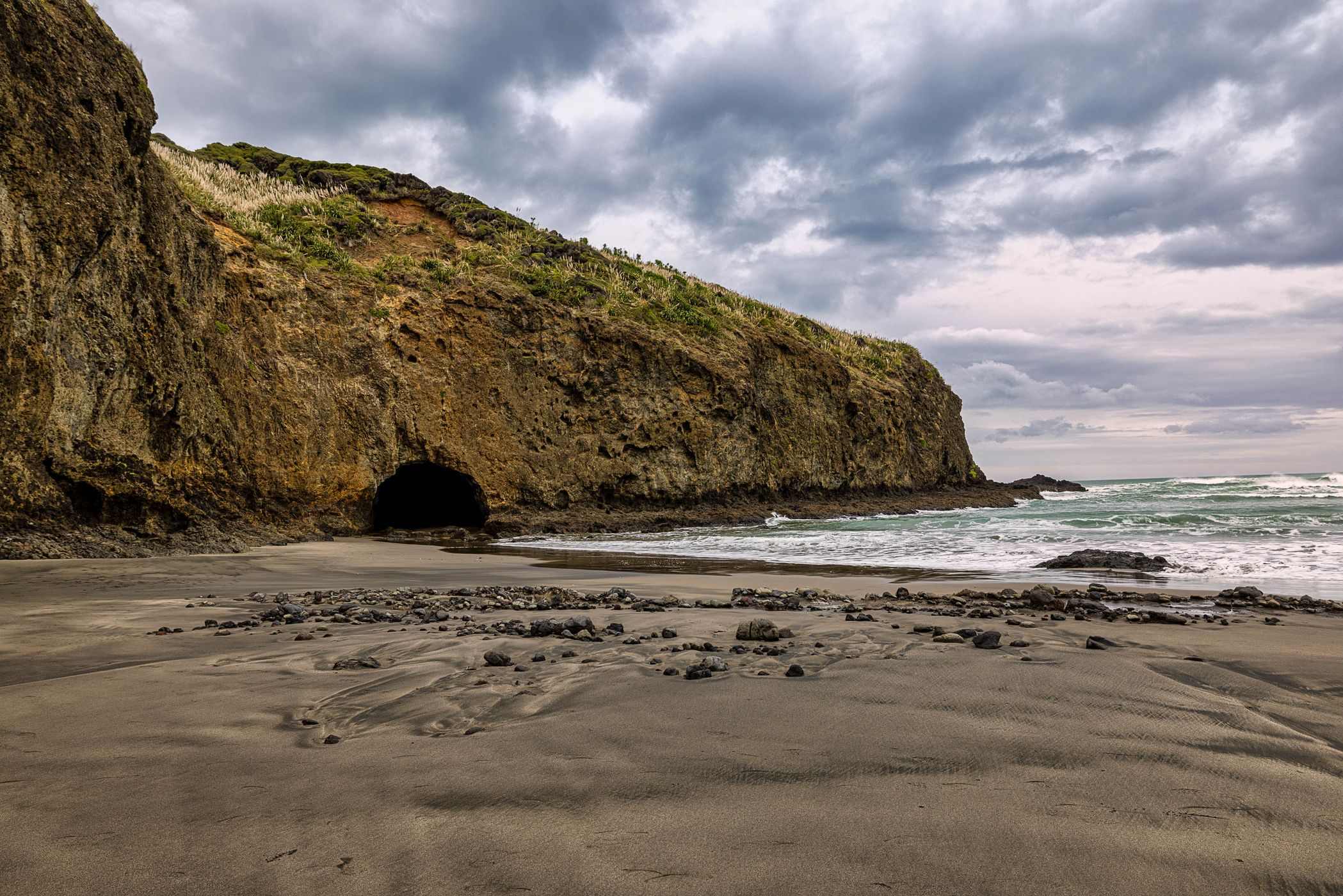 Entrance to the cave Bethells Beach,North Island, New Zealand