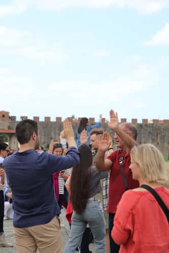 People taking pictures at Leaning Tower of Pisa