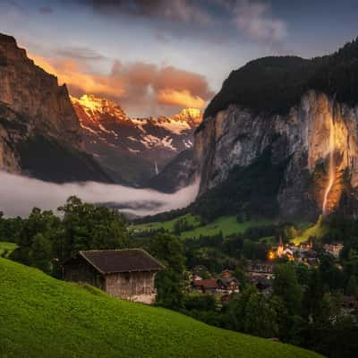 Lauterbrunnen valley with old wooden barn and white peaks, Switzerland