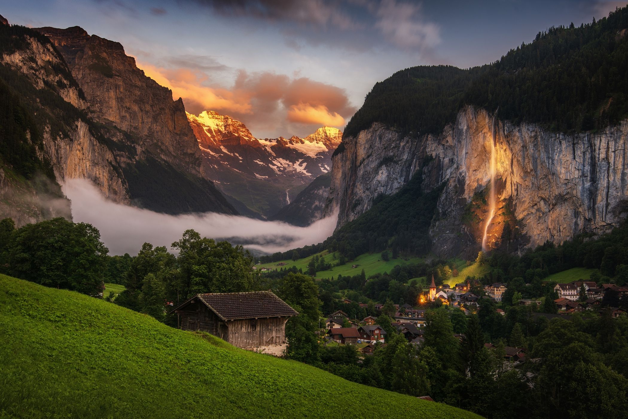 Lauterbrunnen valley with old wooden barn and white peaks, Switzerland