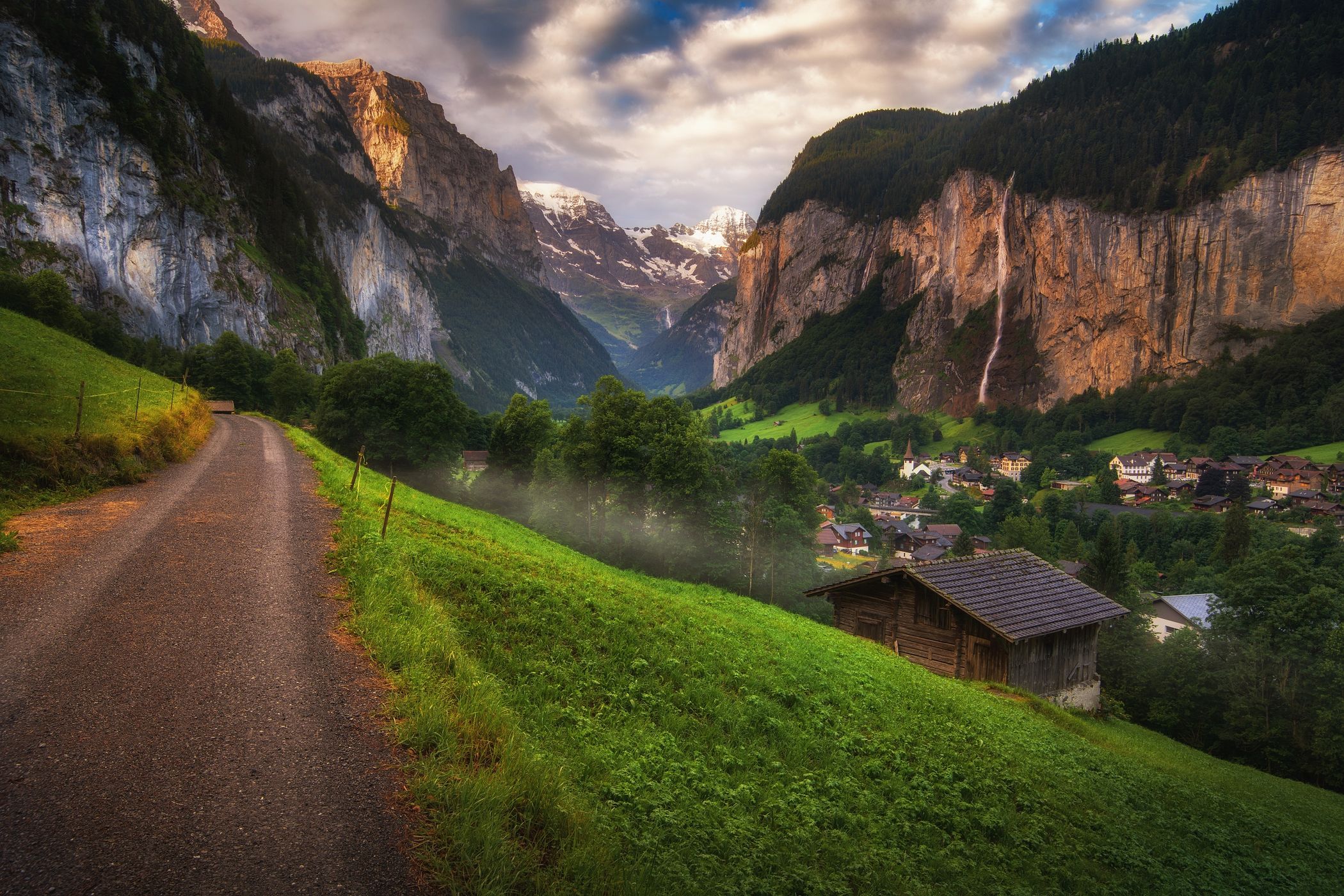 Lauterbrunnen valley with old wooden barn and white peaks, Switzerland