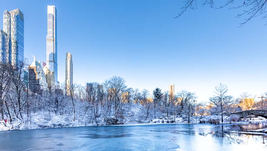 Winter Manhattan skyline reflects in the Central Park Pond