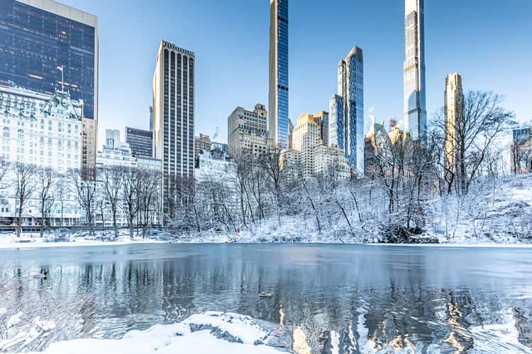 Winter Manhattan skyline reflects in the Central Park Pond