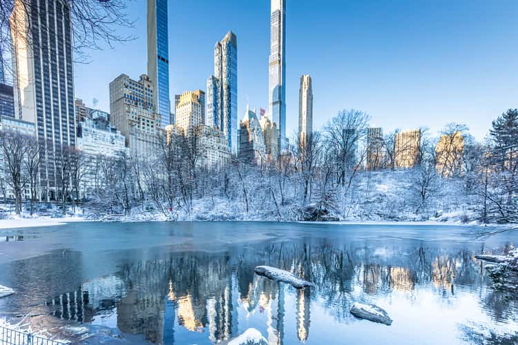 Winter Manhattan skyline reflects in the Central Park Pond