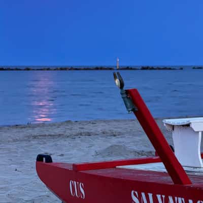 Lifeboat on the beach at full moon, Italy