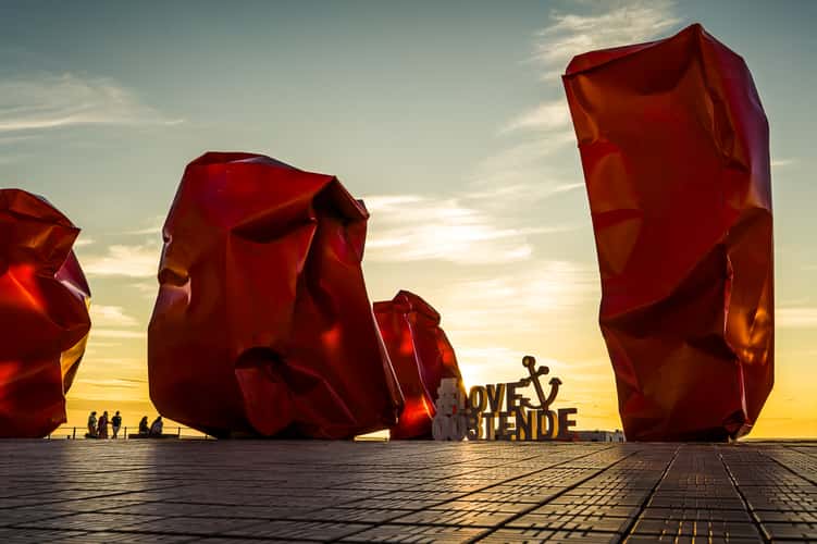Red 'Rock Strangers' Sculpture at harbour's mouth in Ostend