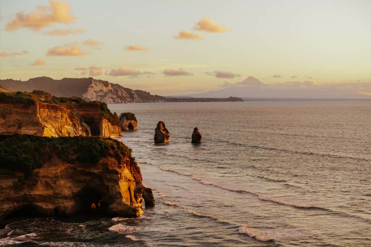Three Sisters with Mount Taranaki in the back, Tongaporutu