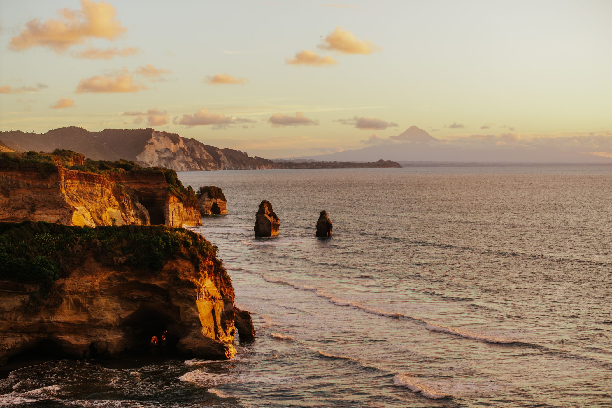 Three Sisters with Mount Taranaki in the back, Tongaporutu, New Zealand