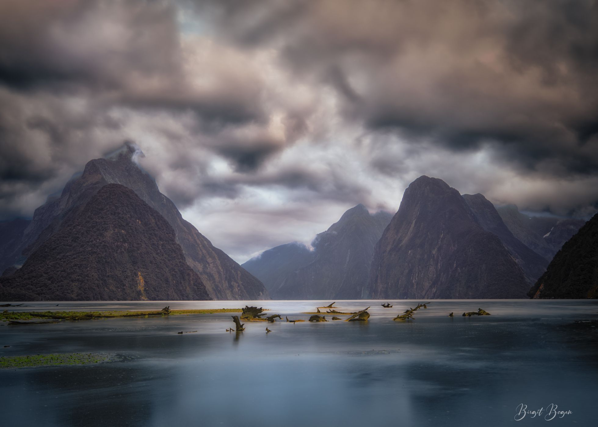 Milford Sound sunset with foreground  rock South Island, New Zealand