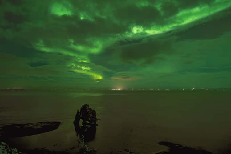Aurora borealis above Hvitserkur, North Iceland