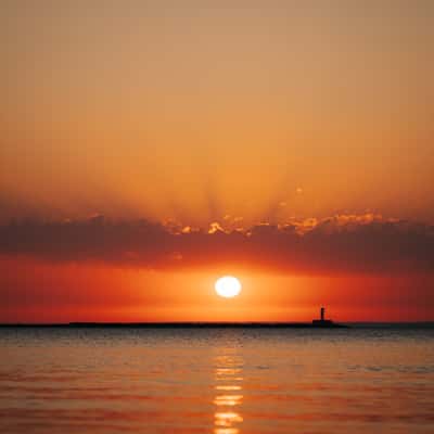 Sunrise at Marquette beach towards Breakwater Light, USA