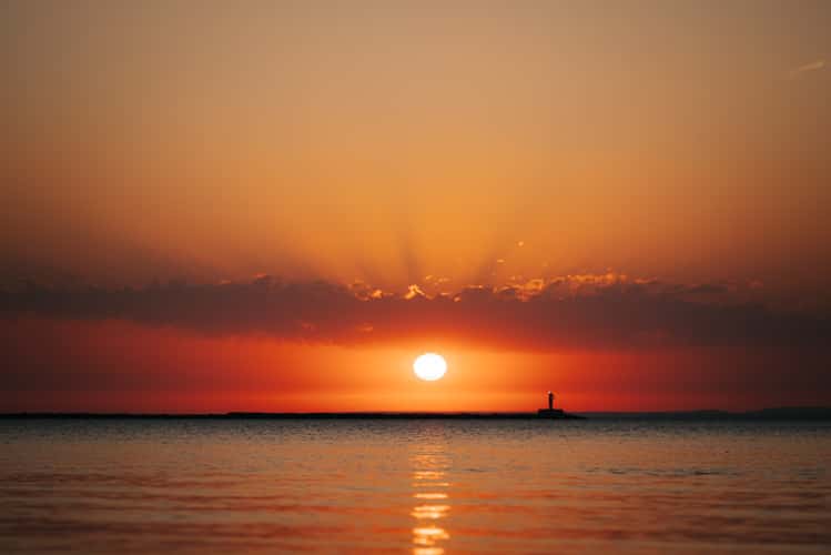 Sunrise at Marquette beach towards Breakwater Light