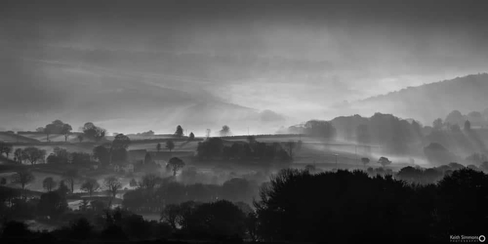 Looking East from Brentor. Early Sun backlighting the Inversion