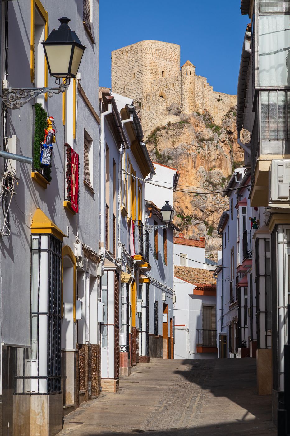 Castle view from Maestro Amado street, Olvera, Spain