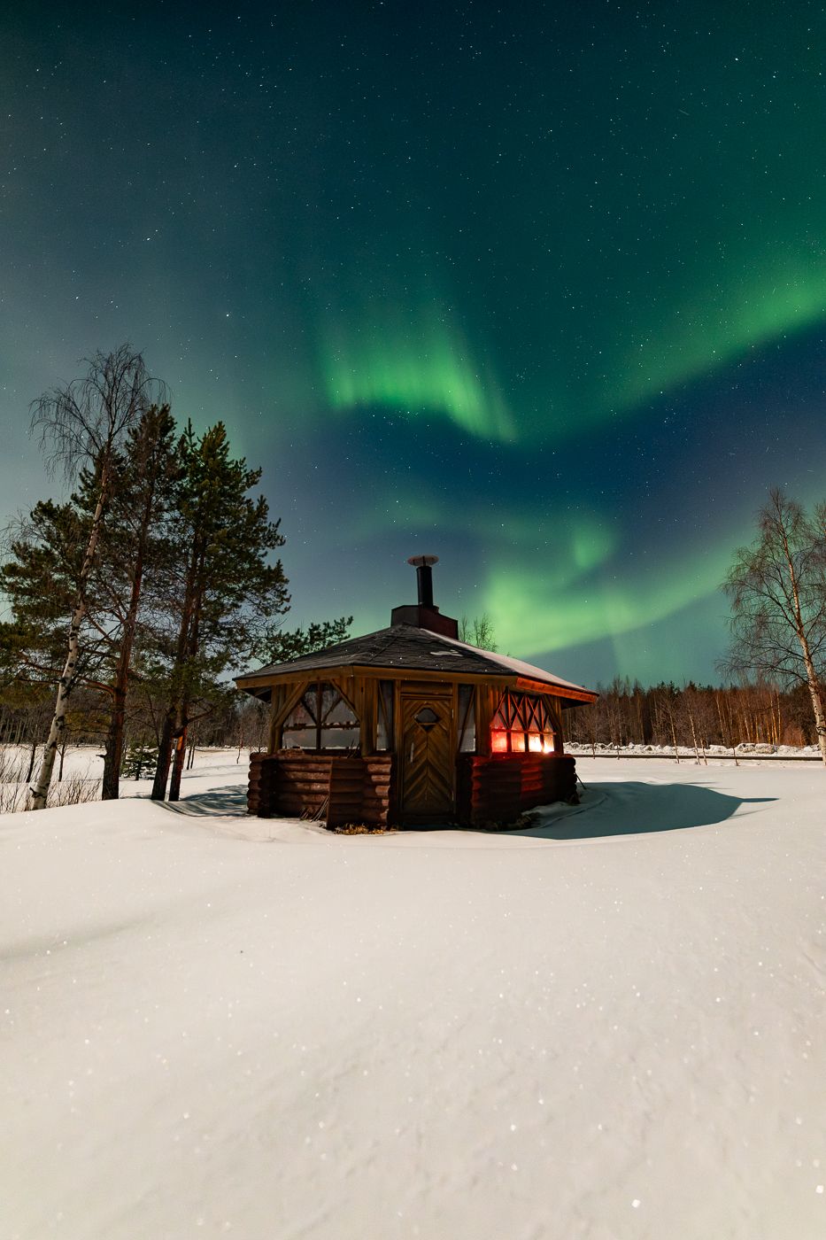 Small hut with auroras, Finland