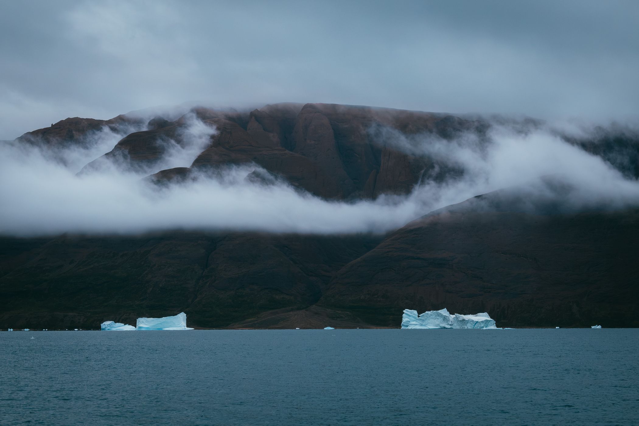 Icebergs and mountains near Rolige Bræ, Rødefjord, Greenland