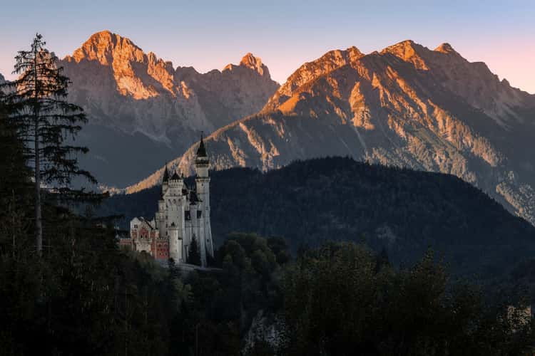 Neuschwanstein Castle with Mountain Range Backdrop