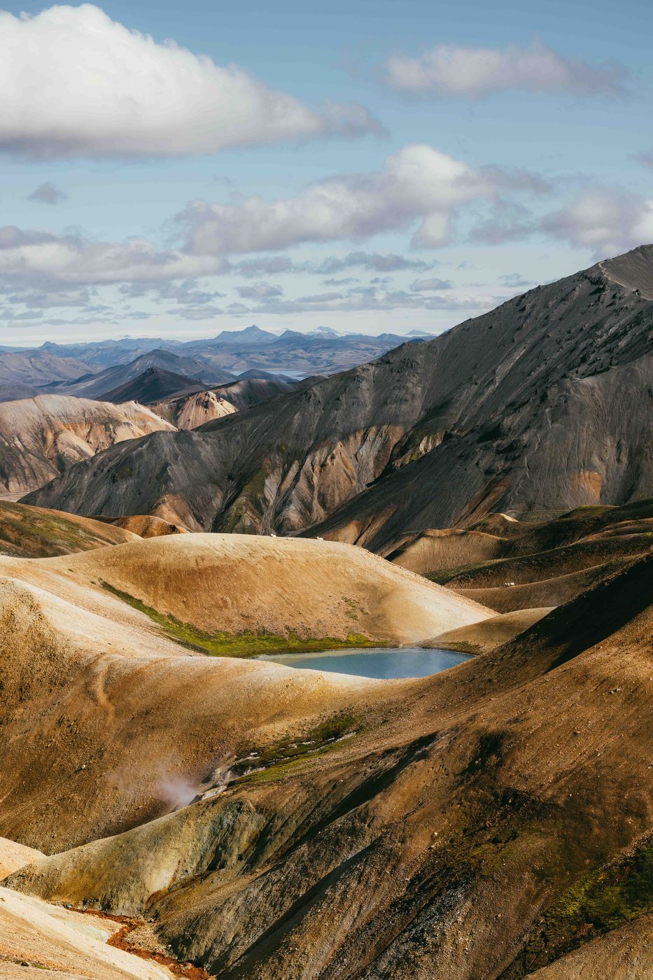 Small blue pond, sheep, structures at Laugavegur trail, Iceland